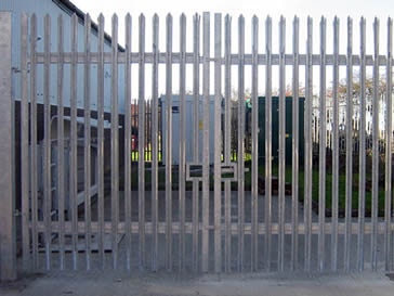 Galvanised palisade double-gate for a factory.