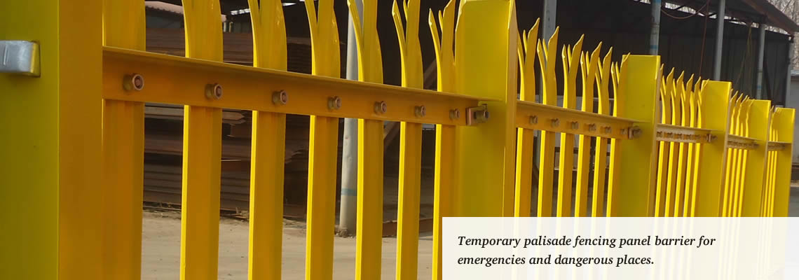 Yellow powder-coated palisade fencing panels used as temporary security fence.